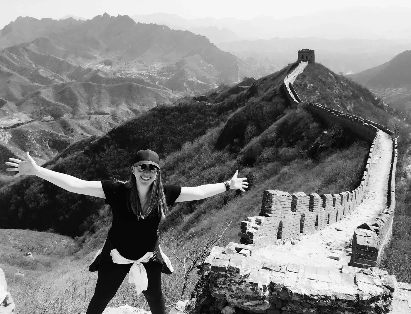 Georgia Sapounas with arms outstretched on the Great Wall of China